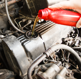 Person Putting Oil in a Car for Auto Maintenance in Manassas, VA