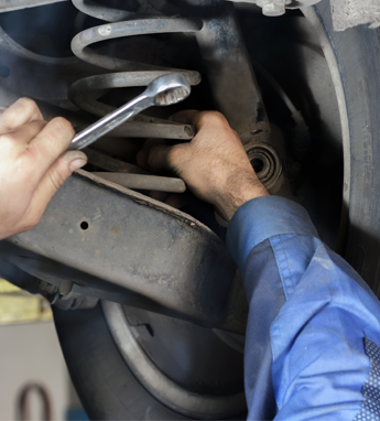 Man Fixing a Cars Spring in Manassas, VA